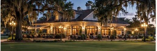 A warmly lit clubhouse patio at dusk